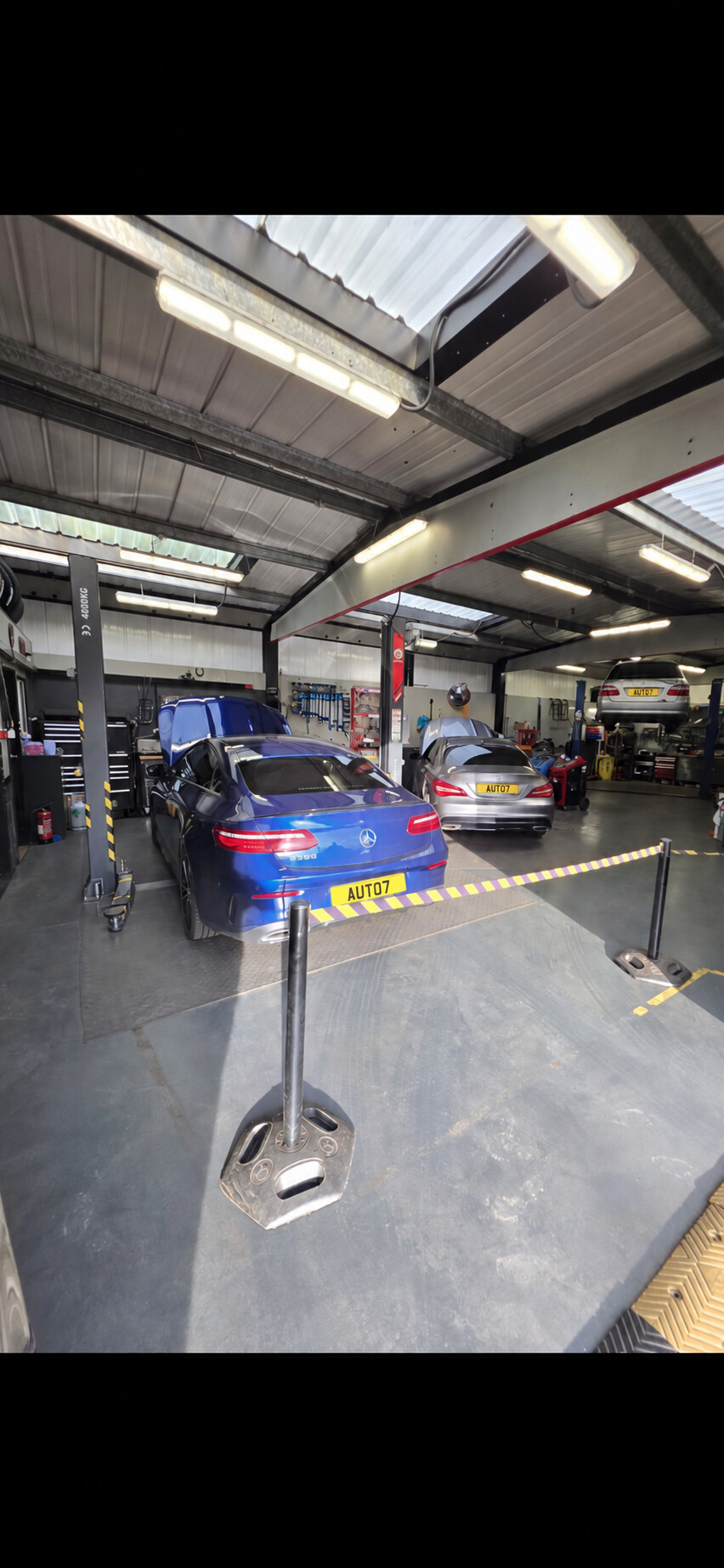 AUTO 7 CENTRE workshop bays with Mercedes-Benz vehicles