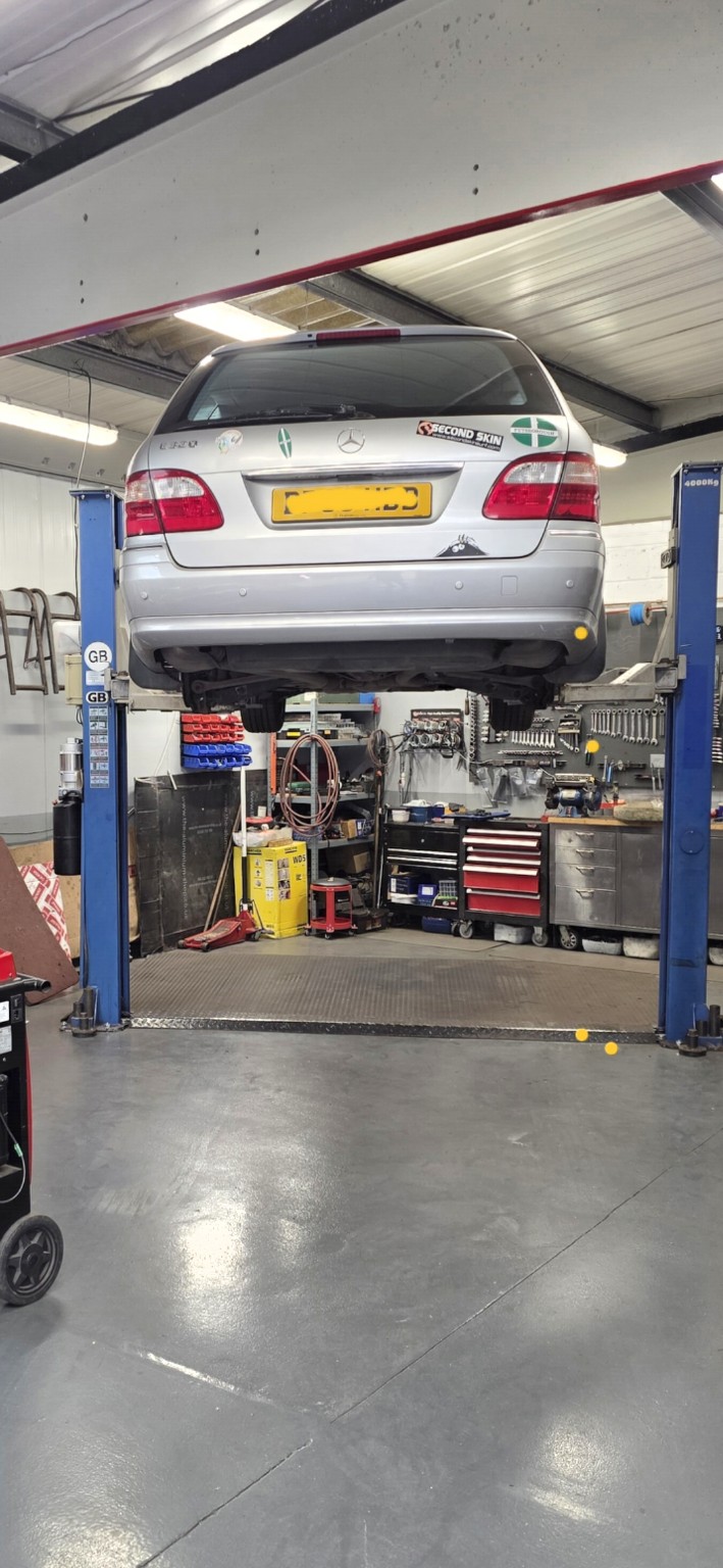 Mercedes-Benz raised on a vehicle lift in the workshop